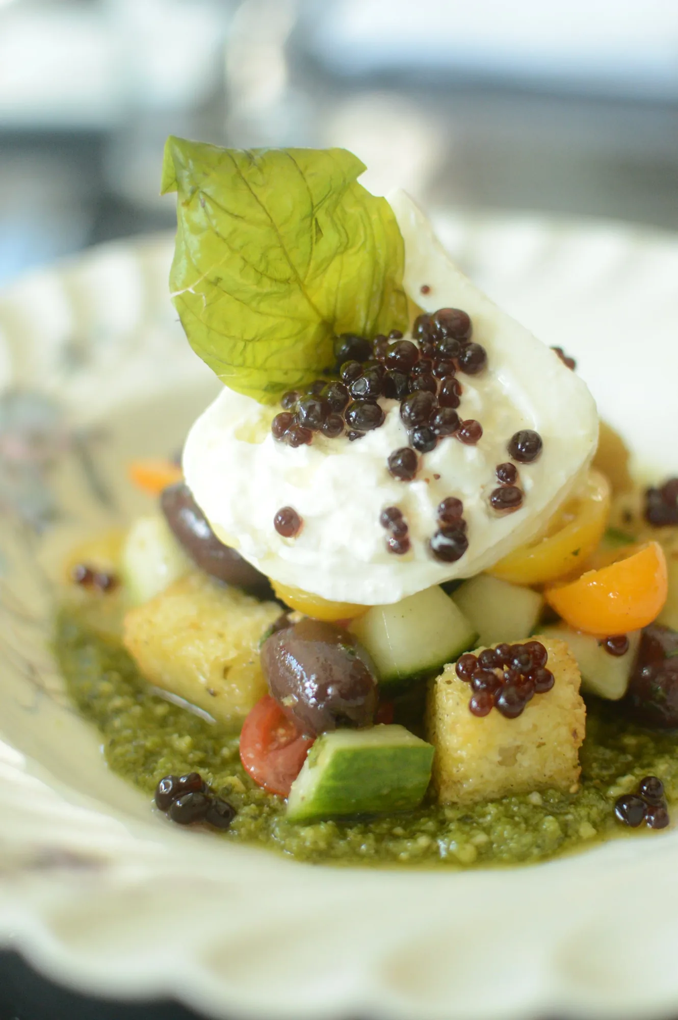 Whipped feta topped with roasted tomatoes and greens, served with grilled bread.